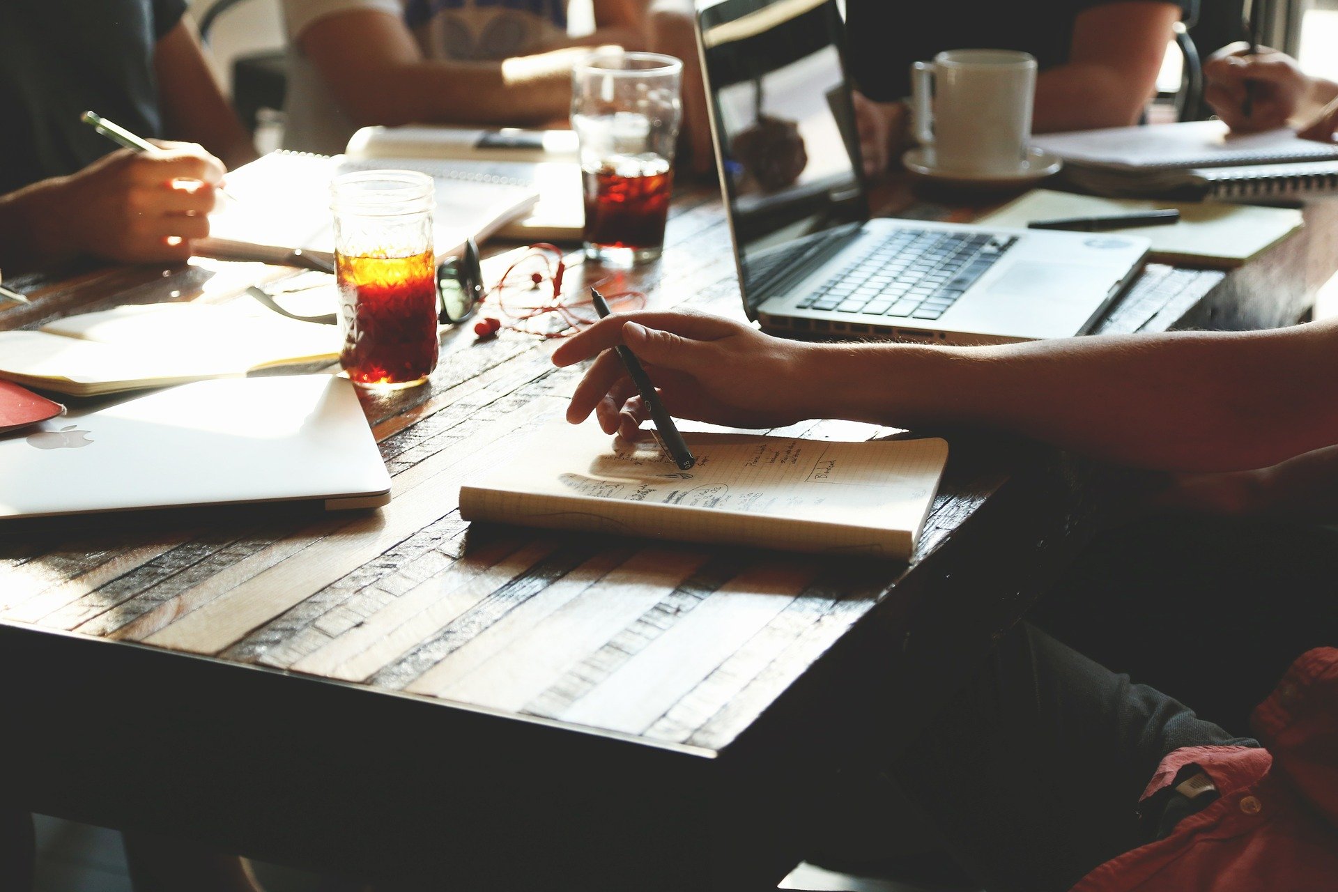 People sitting around a table in a meeting to represent agile software methodology